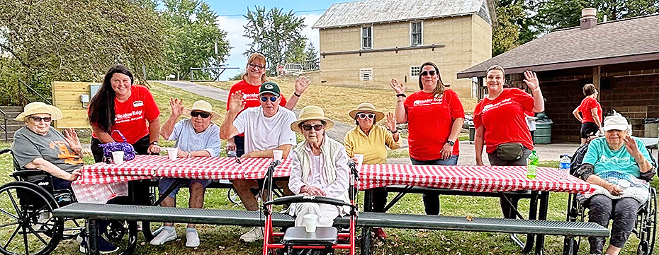 Meadow Ridge staff and residents at Merrimac Memorial Park for a picnic and pontoon boat rides.